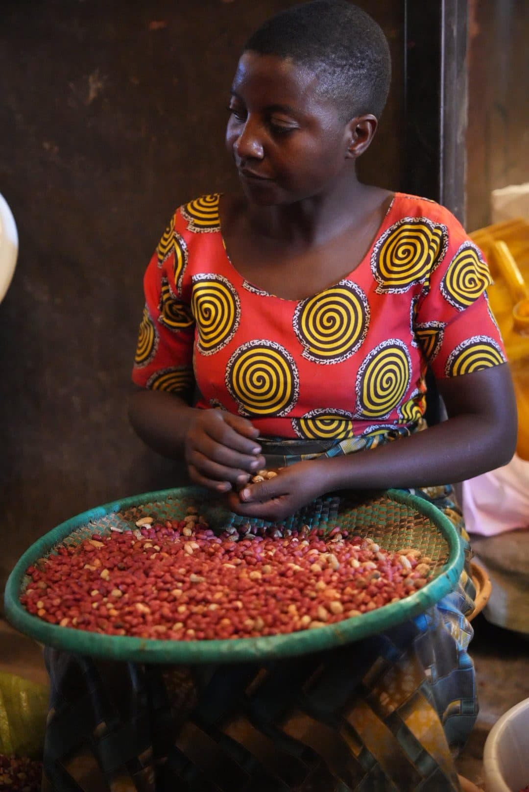 Woman sorting beans at a Kigali market